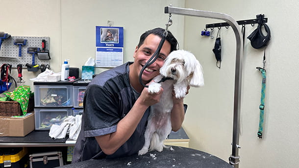 Groomer with dog at VCA Village Park Animal Hospital