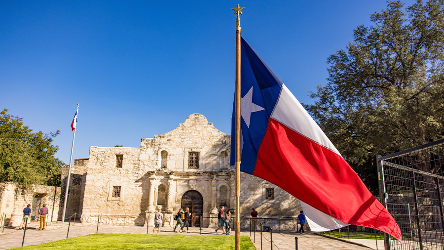 Texas flag in front of the Alamo