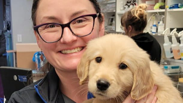 Dr. Sinclair holding a puppy
