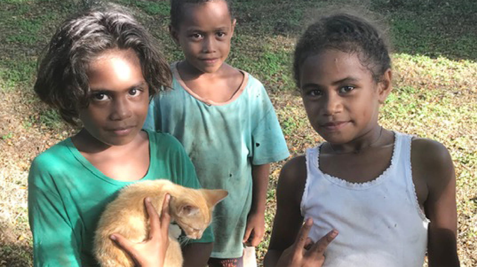 Three kids with a kitten