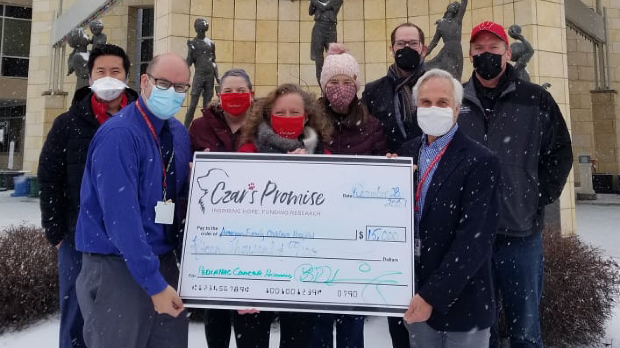 Group photo with donation check
