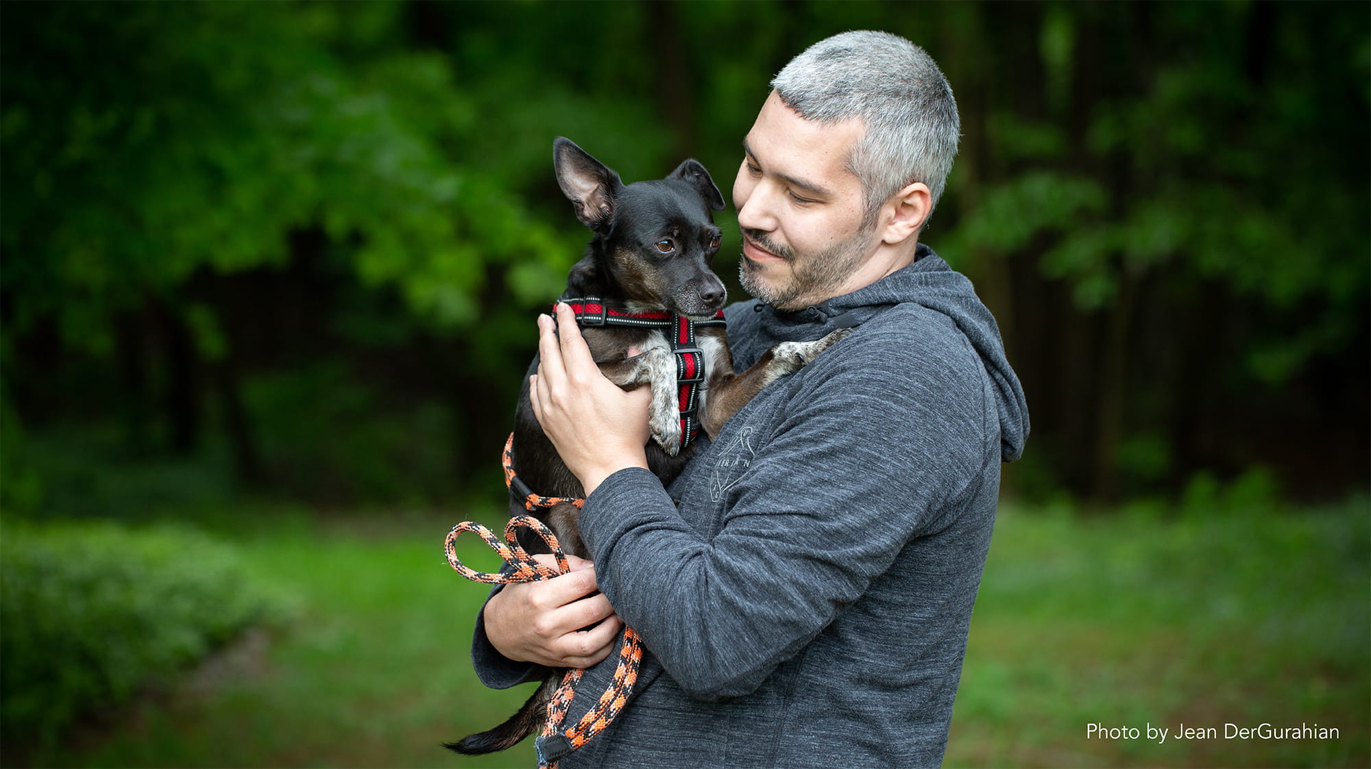 Man Holding Black Chihuahua